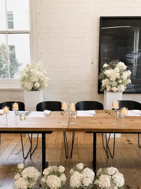 Ceremony flowers repurposed around amanda and bryans head table