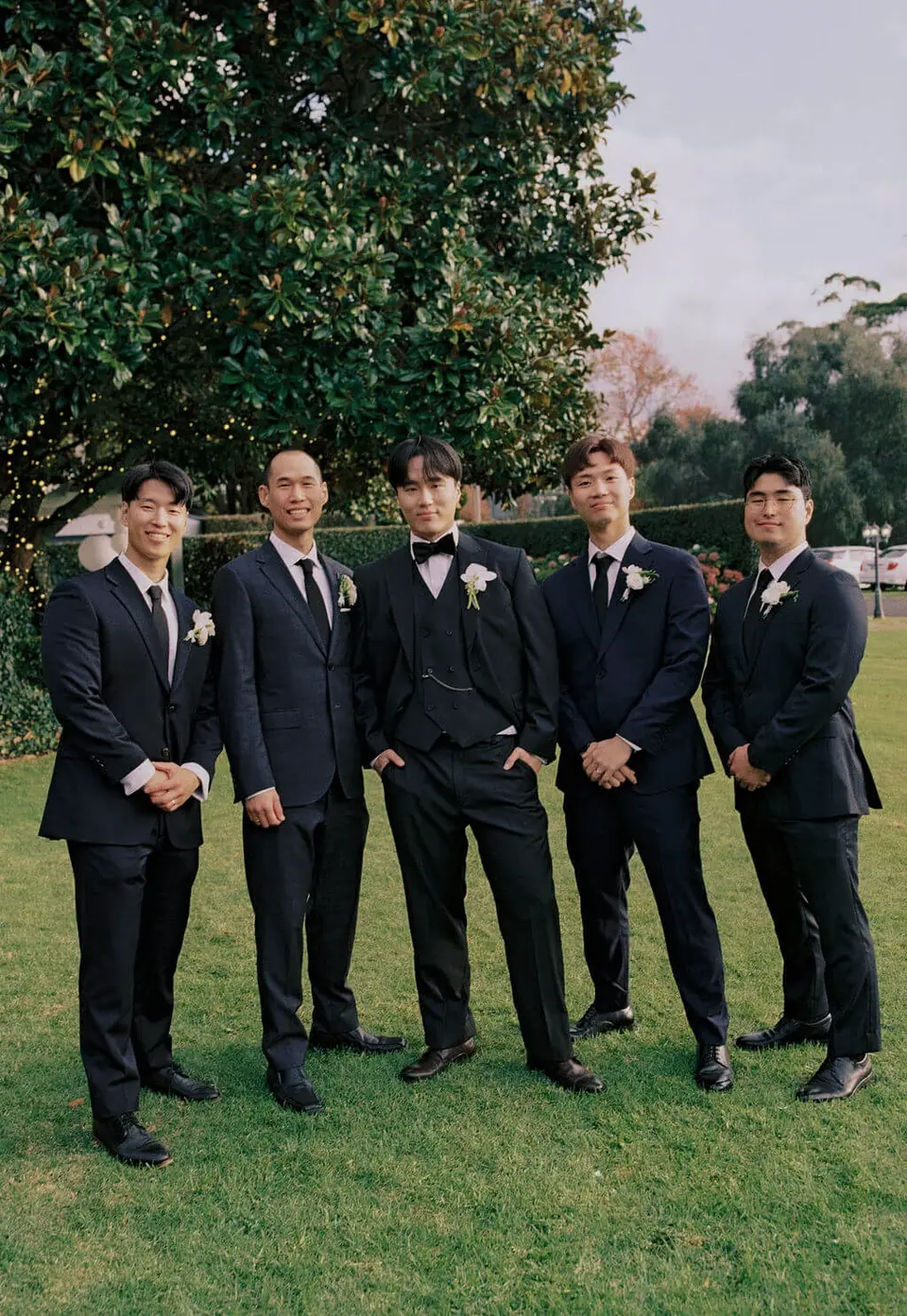 Dan and his groomsmen wearing delicate white and green buttonholes