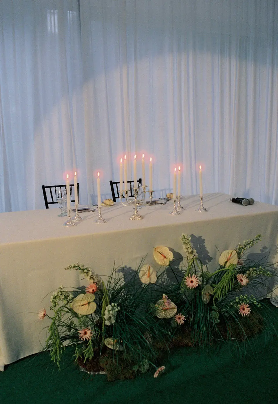 Film photograph of Claire and Dan at their candlelit sweetheart table