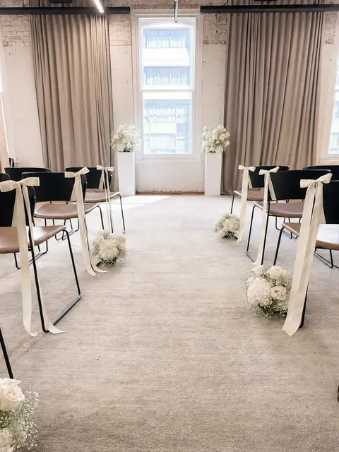 Intimate hotel britomart wedding aisle with ivory ribbon bows
