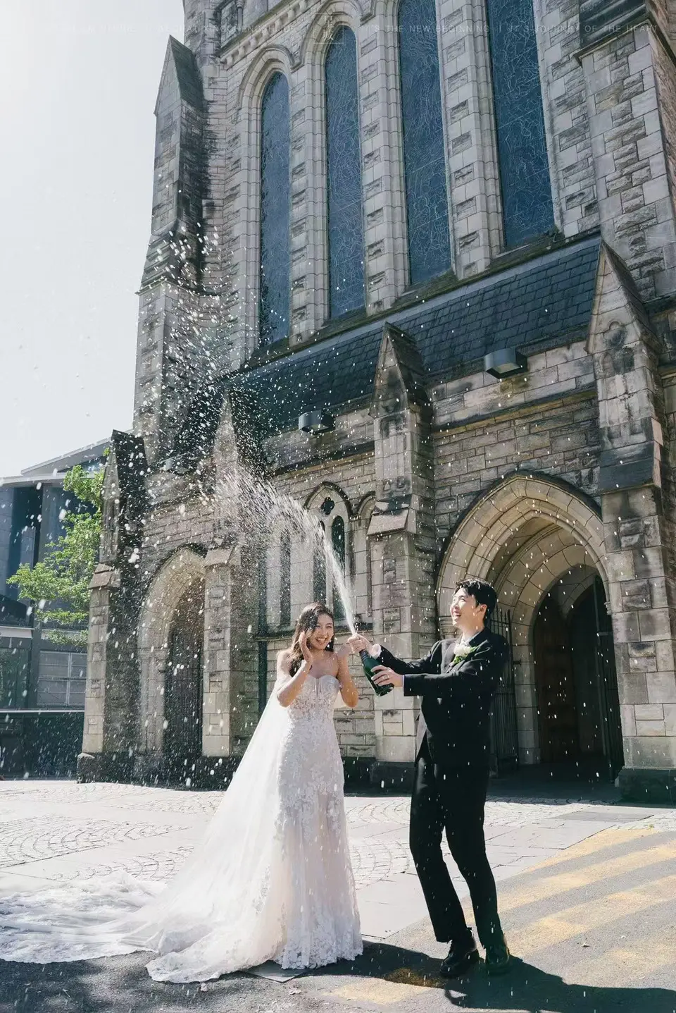 Kaelan and Tongtong celebrating their Auckland elopement outside St Matthew-in-the-City