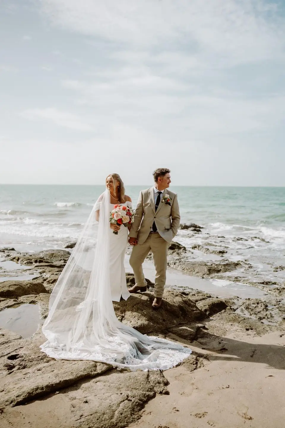 Kate and Ben with their bridal party on the beach after their Takapuna wedding ceremony