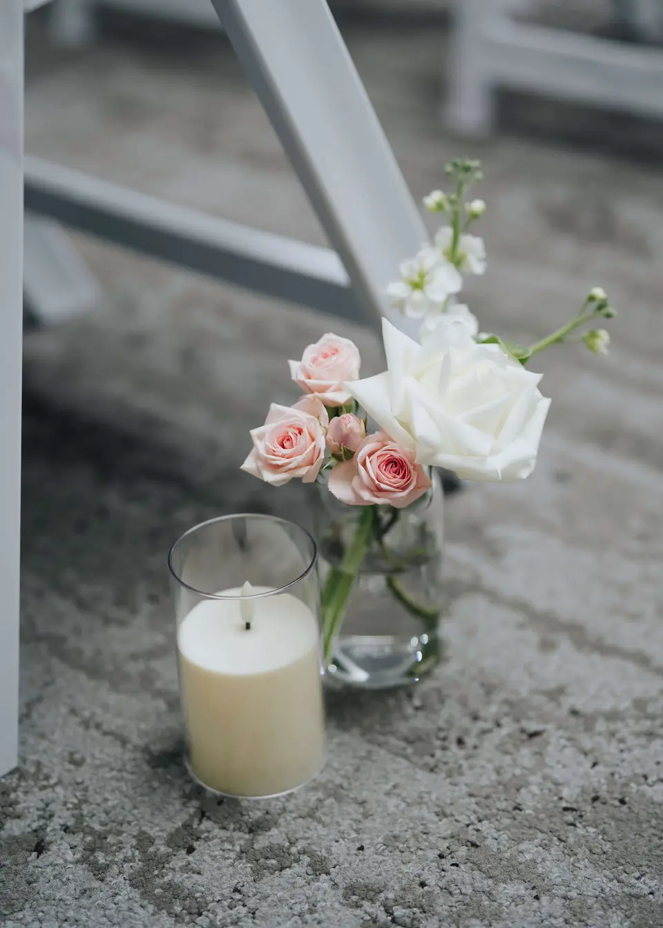 Repurposed blush and white bud vases used as reception table flowers