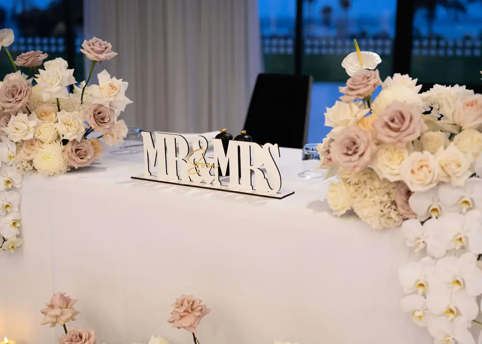 Romantic blush and white head table flowers for a winter wedding at Rydges Formosa Auckland
