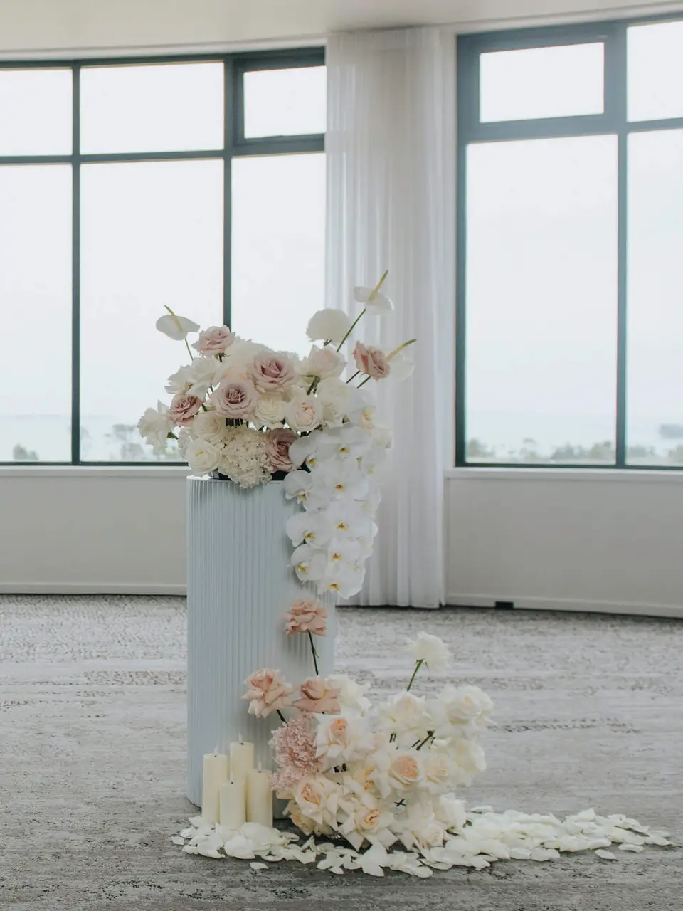 Sarah and Samuel's blush and white ceremony flowers with soft candlelight