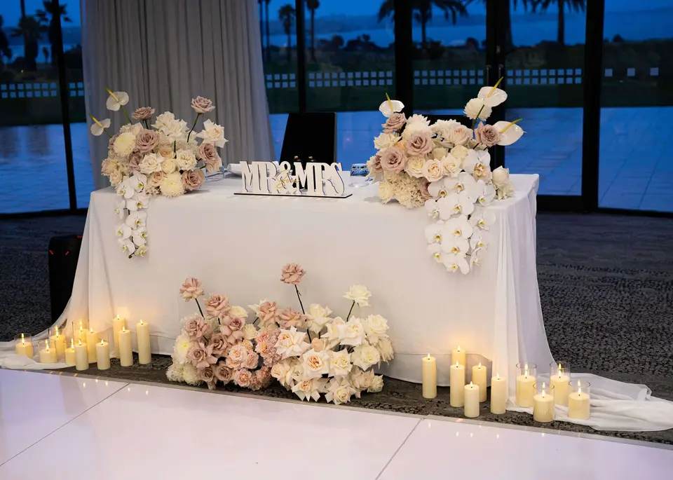 Soft romantic wedding reception styling with candlelight and blush white flowers at Rydges Formosa Auckland