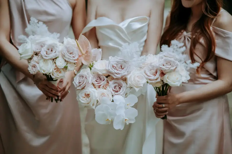 Bridesmaids holding blush and ivory bouquets by Willow & Peony, Auckland