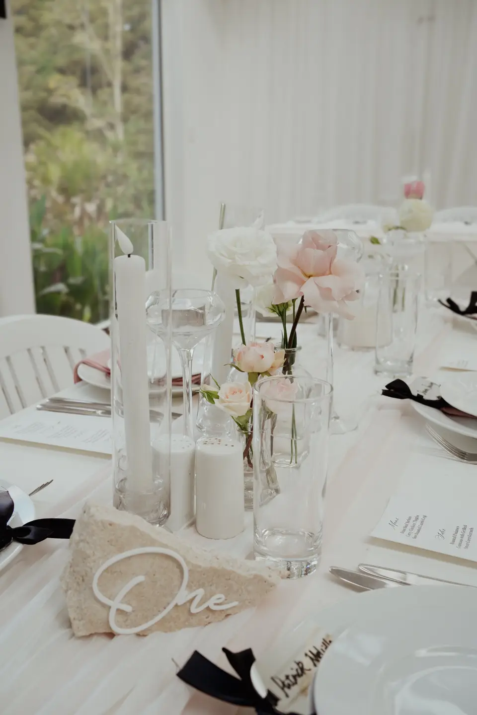 Sculptural white and blush wedding flowers on a plinth